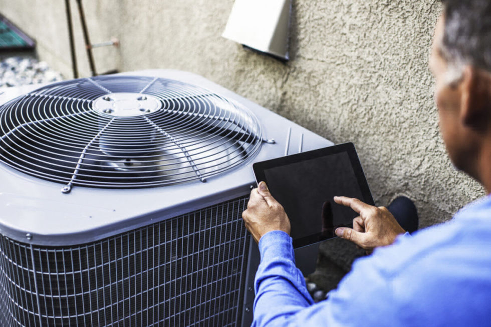 Home Inspector examining air conditioner 